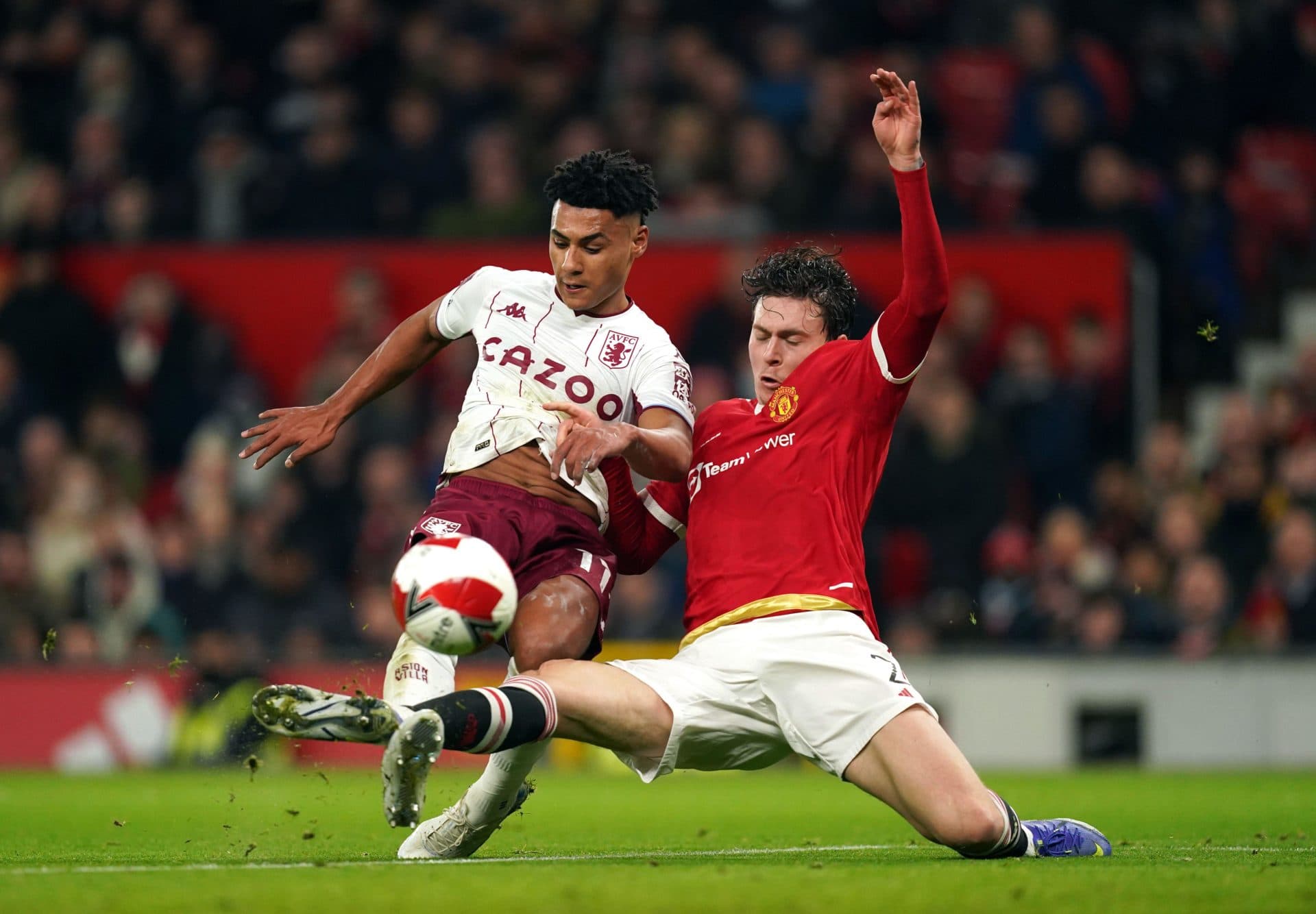 Manchester United's Victor Lindelof (right) challenges Aston Villa's Ollie Watkins during the Emirates FA Cup third round match at Old Trafford