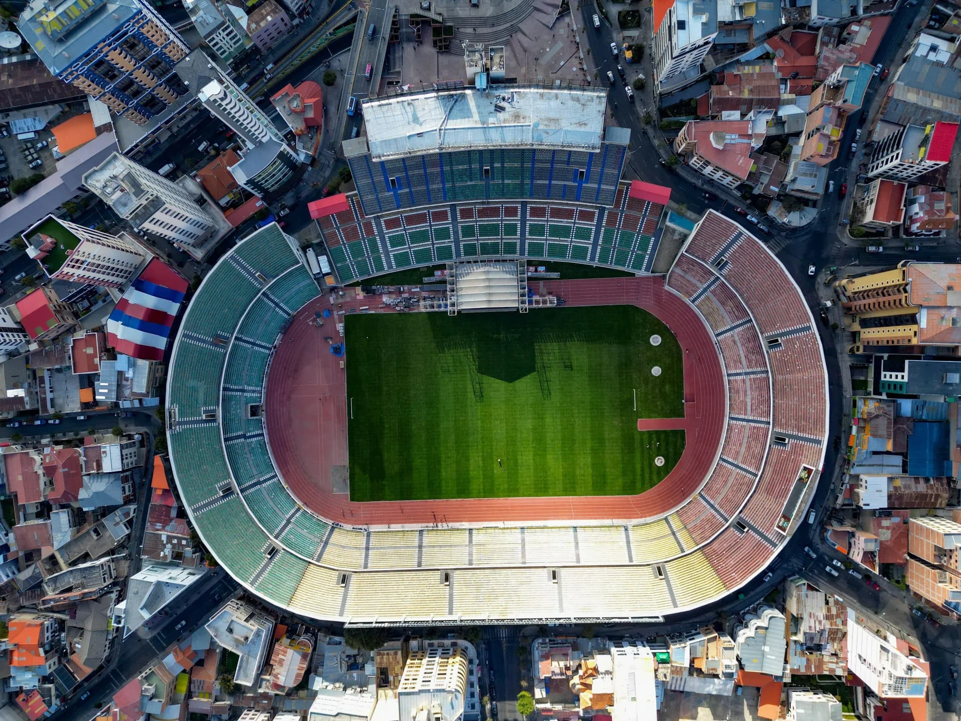 Aerial view of hernando siles stadium in la paz, bolivia, nestled amidst the urban landscape, showcasing its prominent presence