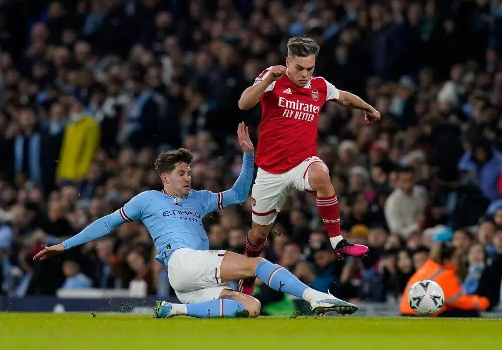 Manchester, England, 27th January 2023. John Stones of Manchester City tackles Leandro Trossard of Arsenal during the The FA Cup match at the Etihad Stadium, Manchester. Picture credit should read: Andrew Yates / Sportimage Credit: Sportimage/Alamy Live News