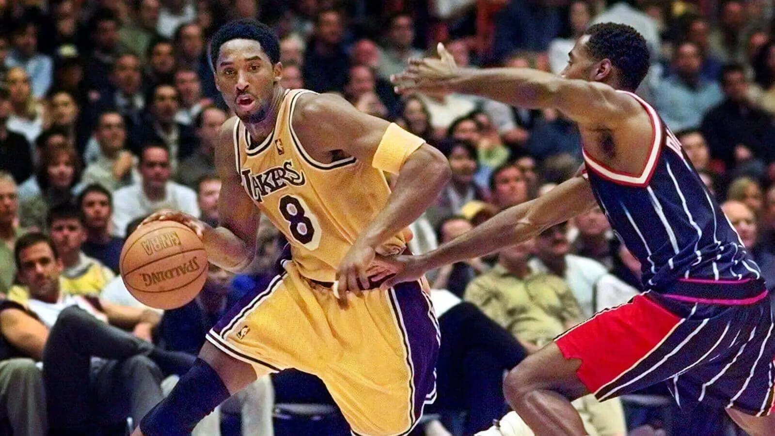 Kobe Bryant drives toward the basket as Houston Rockets' Michael Dickerson guards
