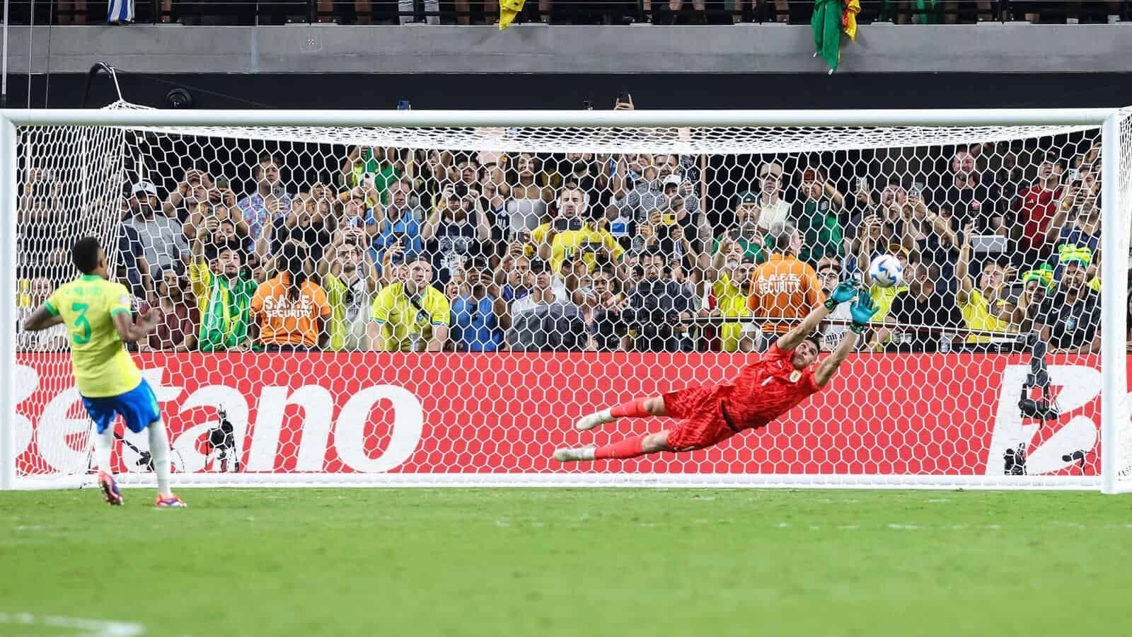 Uruguay goalkeeper Sergio Rochet (1) blocks a penalty kick by Brazil defender Militao